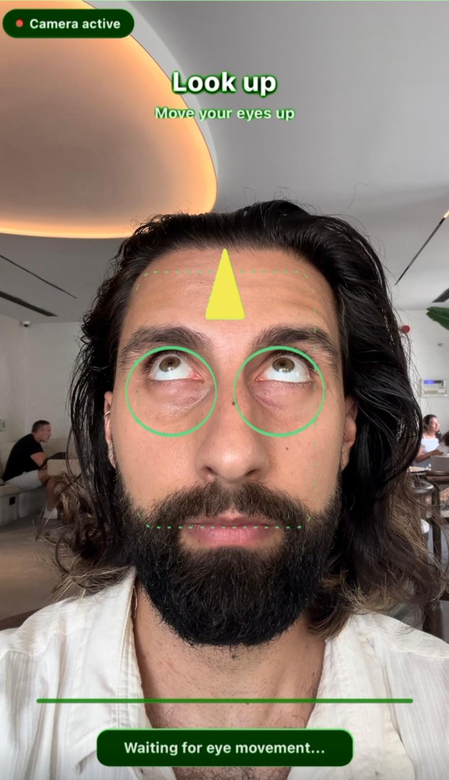 EyeUnlock tracking a user's eyes with green rings and a yellow 'Look up' arrow